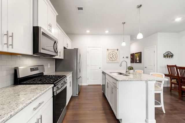 4206 Grapevine Loop, Smyrna, TN 37167 - kitchen featuring stainless steel appliances, tasteful backsplash, dark wood-type flooring, an island with sink, and recessed lighting