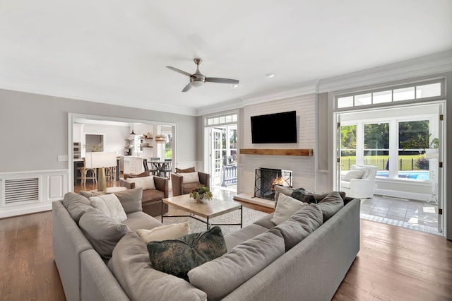 904 Oxford Ct, Brentwood, TN 37027 - living room with crown molding, ceiling fan, a brick fireplace, plenty of natural light, and wood finished floors