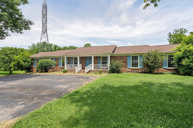 2208 Bowman Rd, Franklin, TN 37064 - ranch-style home featuring covered porch, brick siding, asphalt driveway, and a front lawn