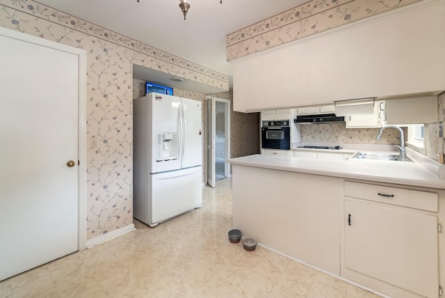 2208 Bowman Rd, Franklin, TN 37064 - kitchen featuring black appliances, wallpapered walls, light floors, light countertops, and range hood
