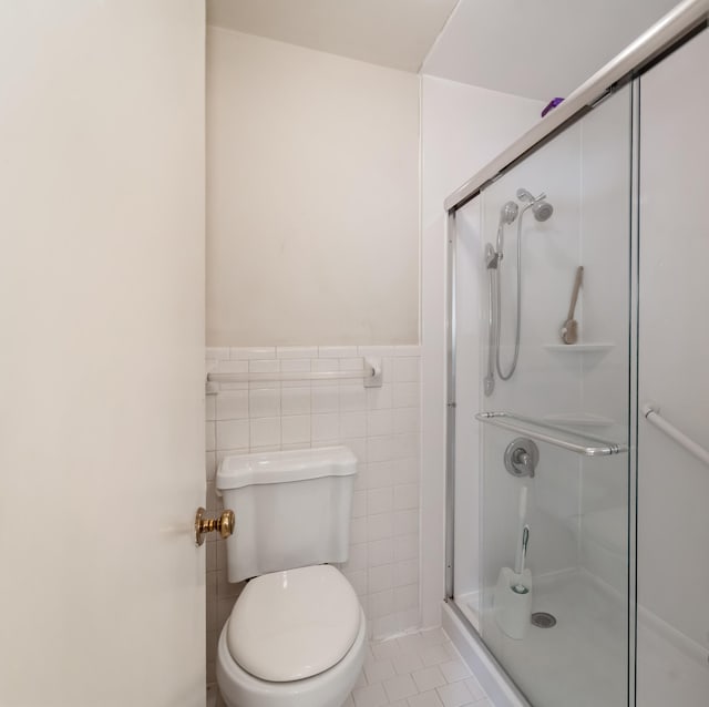 2208 Bowman Rd, Franklin, TN 37064 - full bathroom featuring a stall shower, a wainscoted wall, tile patterned floors, and tile walls