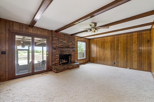 2208 Bowman Rd, Franklin, TN 37064 - unfurnished living room with ceiling fan, wooden walls, carpet, beam ceiling, and a brick fireplace