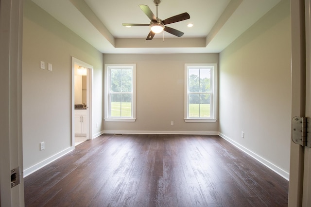 264 Dink Rut Rd, Portland, TN 37148 - empty room featuring dark wood-type flooring, ceiling fan, and a raised ceiling