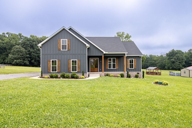 264 Dink Rut Rd, Portland, TN 37148 - modern inspired farmhouse with board and batten siding, a front lawn, and an outbuilding