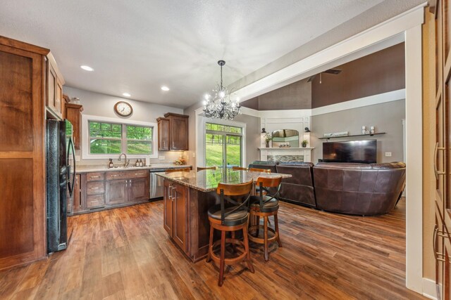 3092 Morel Rd, Columbia, TN 38401 - kitchen with stainless steel dishwasher, freestanding refrigerator, a kitchen island, dark wood-style flooring, and a breakfast bar