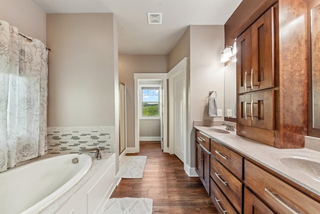 3092 Morel Rd, Columbia, TN 38401 - full bath with a garden tub, double vanity, a stall shower, and wood finished floors
