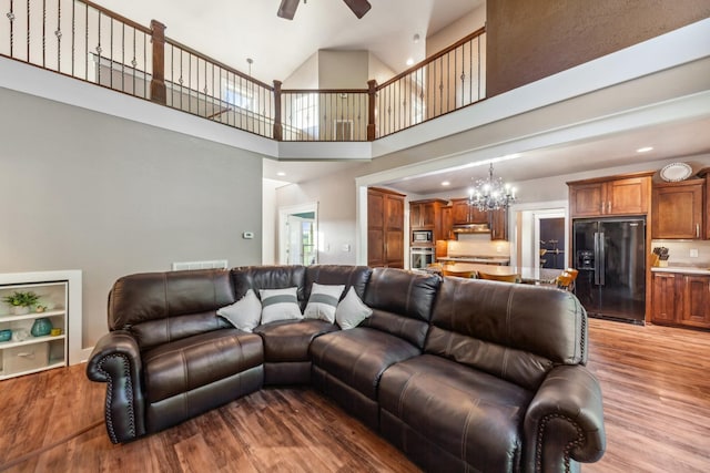 3092 Morel Rd, Columbia, TN 38401 - living area with light wood-type flooring, a ceiling fan, a chandelier, a towering ceiling, and recessed lighting
