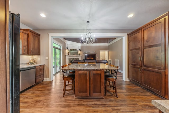 3092 Morel Rd, Columbia, TN 38401 - kitchen featuring stainless steel dishwasher, a kitchen breakfast bar, dark wood-type flooring, open floor plan, and hanging light fixtures