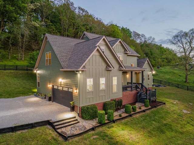 3092 Morel Rd, Columbia, TN 38401 - view of front of property with board and batten siding, driveway, a shingled roof, and a garage