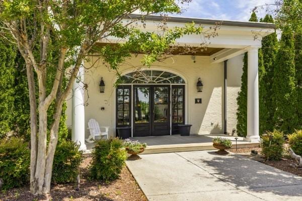 1328 Reynard Dr, Gallatin, TN 37066 - entrance to property with french doors, stucco siding, and a porch