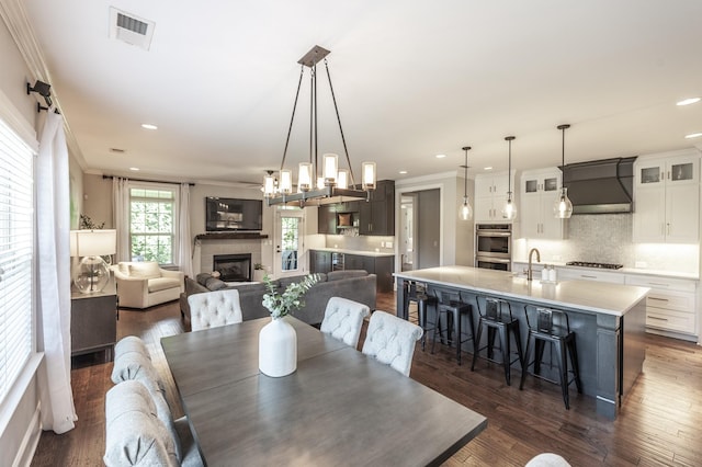 1328 Reynard Dr, Gallatin, TN 37066 - dining area with crown molding, a tiled fireplace, dark wood finished floors, and recessed lighting