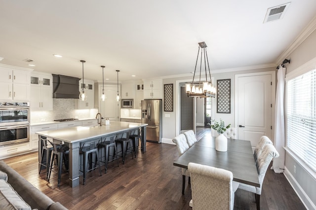 1328 Reynard Dr, Gallatin, TN 37066 - dining area featuring dark wood finished floors, a chandelier, crown molding, and recessed lighting