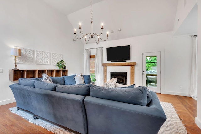 2779 Landcashire Ct, Thompsons Station, TN 37179 - living area featuring a chandelier, a fireplace, light wood-style flooring, and high vaulted ceiling