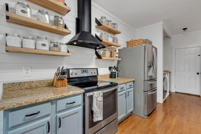 2779 Landcashire Ct, Thompsons Station, TN 37179 - kitchen featuring stainless steel appliances, open shelves, wall chimney range hood, washer / clothes dryer, and light wood-type flooring