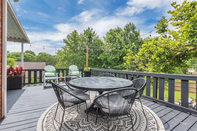 2779 Landcashire Ct, Thompsons Station, TN 37179 - wooden deck with outdoor dining space and view of wooded area