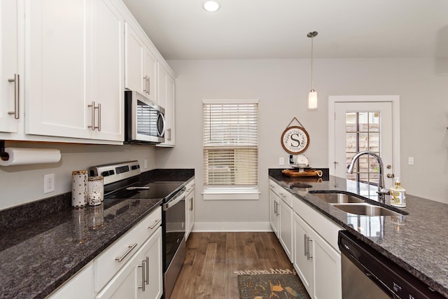 2163 Bayport Ave, Old Hickory, TN 37138 - kitchen with stainless steel appliances, white cabinetry, dark wood-type flooring, hanging light fixtures, and dark stone counters