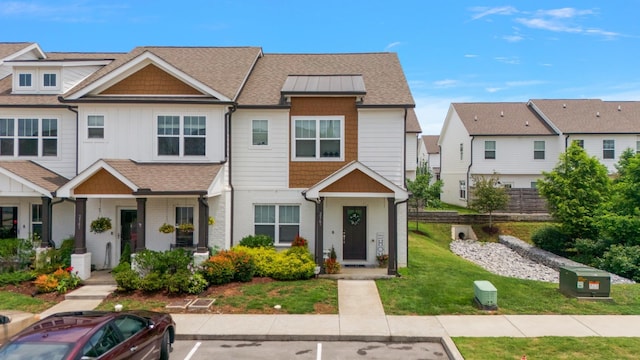 2163 Bayport Ave, Old Hickory, TN 37138 - view of property featuring a front lawn, roof with shingles, uncovered parking, board and batten siding, and brick siding