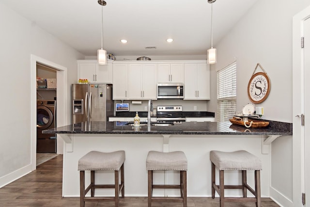2163 Bayport Ave, Old Hickory, TN 37138 - kitchen featuring stainless steel appliances, washer / dryer, white cabinetry, a breakfast bar, and recessed lighting