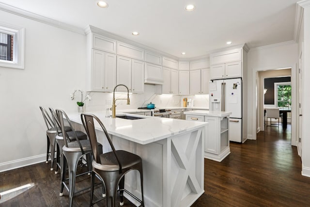 305 White Moss Pl, Franklin, TN 37064 - kitchen with white fridge with ice dispenser, a peninsula, dark wood-type flooring, crown molding, and white cabinetry