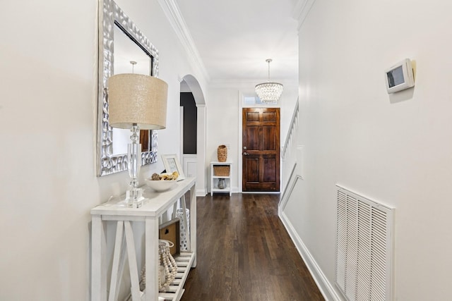 305 White Moss Pl, Franklin, TN 37064 - doorway to outside with arched walkways, dark wood-style flooring, crown molding, and a chandelier