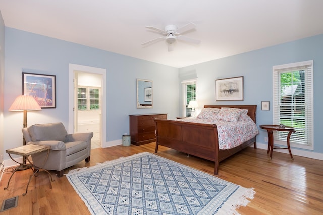 238 Wiggins Creek Dr, Sewanee, TN 37375 - bedroom with light wood finished floors, a ceiling fan, and connected bathroom