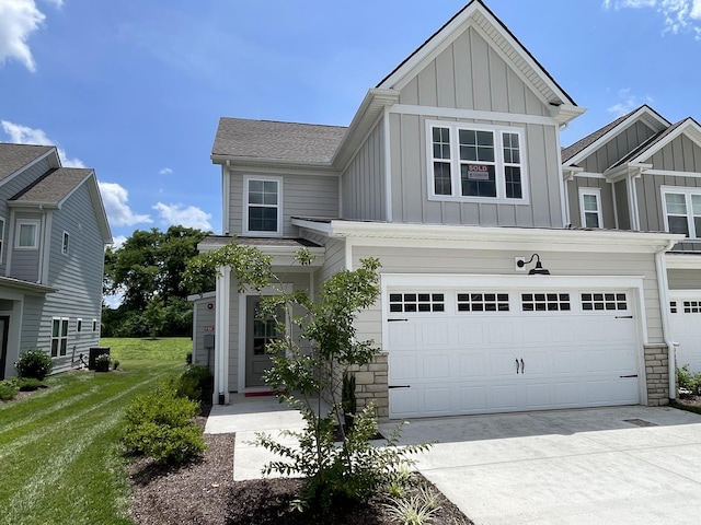 1169 Short St, Spring Hill, TN 37174 - view of front of property with board and batten siding, concrete driveway, a garage, stone siding, and a front lawn