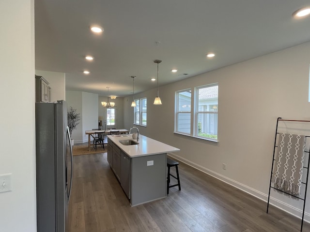 1169 Short St, Spring Hill, TN 37174 - kitchen featuring freestanding refrigerator, an island with sink, a breakfast bar area, dark wood finished floors, and recessed lighting
