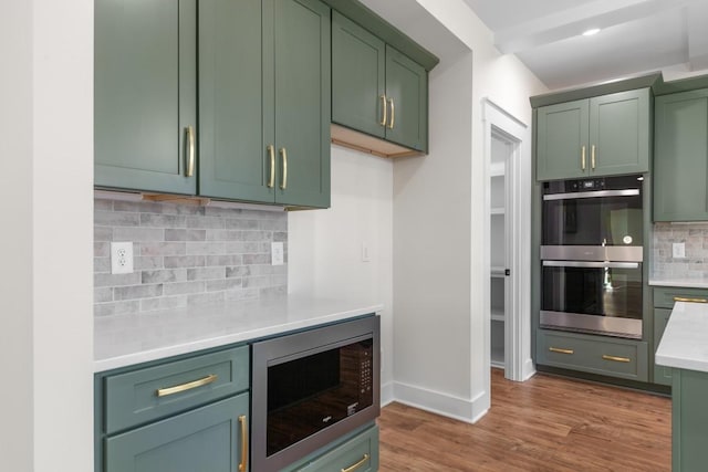 17 Peyton Pl, Columbia, TN 38401 - kitchen with stainless steel appliances, green cabinets, light countertops, tasteful backsplash, and wood finished floors