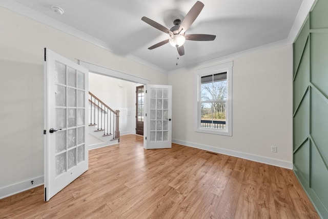 17 Peyton Pl, Columbia, TN 38401 - empty room with french doors, crown molding, ceiling fan, light wood-style floors, and stairs