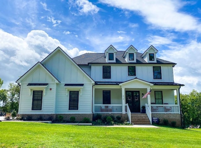 17 Peyton Pl, Columbia, TN 38401 - view of front of home with board and batten siding, covered porch, a front yard, and french doors