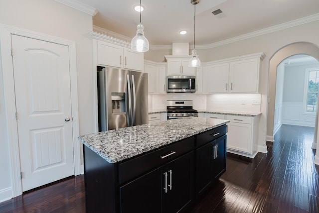 1210 Black Rd, Cunningham, TN 37052 - kitchen featuring appliances with stainless steel finishes, arched walkways, dark cabinets, white cabinets, and ornamental molding