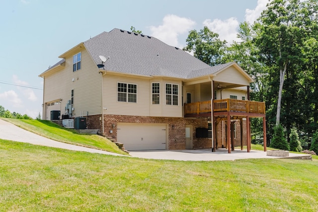 1210 Black Rd, Cunningham, TN 37052 - rear view of house with a garage, brick siding, a yard, a deck, and driveway