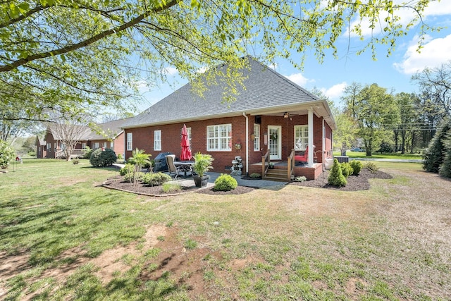 939 Central Valley Rd, Murfreesboro, TN 37129 - rear view of house with brick siding, roof with shingles, a patio area, and a yard