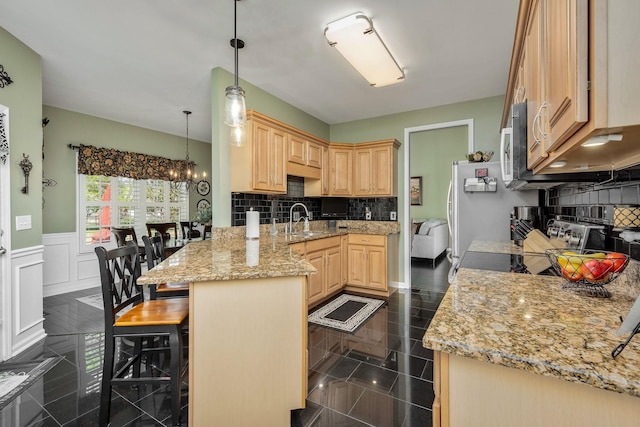 939 Central Valley Rd, Murfreesboro, TN 37129 - kitchen with stainless steel microwave, light brown cabinetry, a peninsula, a kitchen bar, and tasteful backsplash