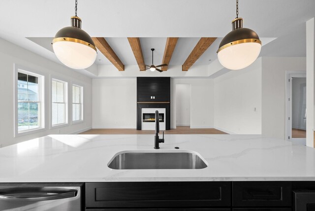 4015 Trough Springs Rd, Adams, TN 37010 - kitchen featuring open floor plan, stainless steel dishwasher, dark cabinets, beamed ceiling, and light stone countertops