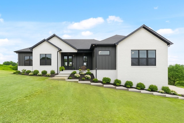 4015 Trough Springs Rd, Adams, TN 37010 - modern farmhouse style home with board and batten siding, a front lawn, and a shingled roof