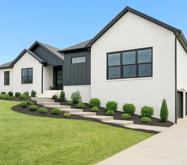 4015 Trough Springs Rd, Adams, TN 37010 - modern inspired farmhouse with board and batten siding, a front lawn, brick siding, and driveway