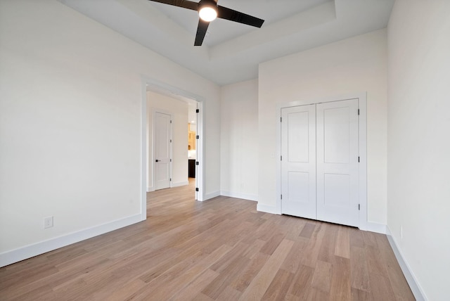 4015 Trough Springs Rd, Adams, TN 37010 - unfurnished bedroom featuring light wood-type flooring, a ceiling fan, a closet, and a raised ceiling