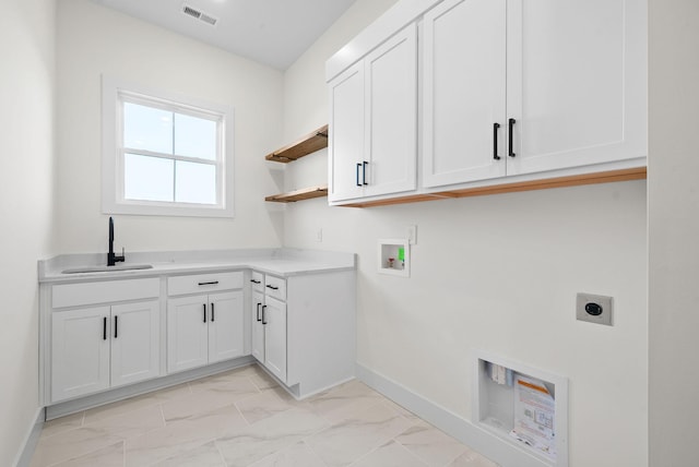 4015 Trough Springs Rd, Adams, TN 37010 - laundry area featuring electric dryer hookup, cabinet space, light marble finish floors, and hookup for a washing machine
