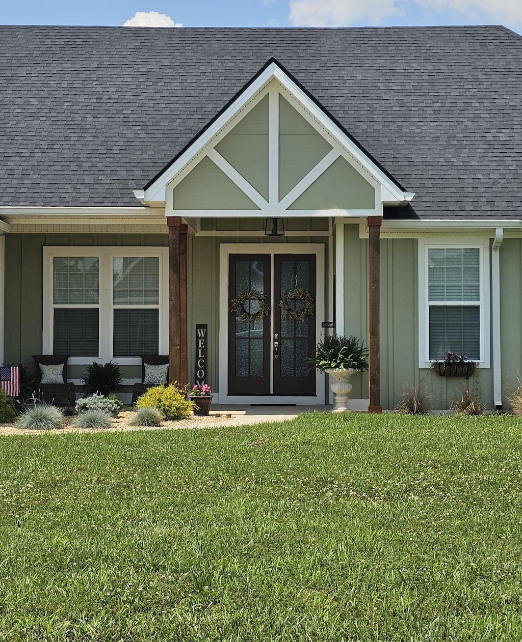 246 Lookout Dr, Winchester, TN 37398 - property entrance featuring roof with shingles, a lawn, board and batten siding, and french doors