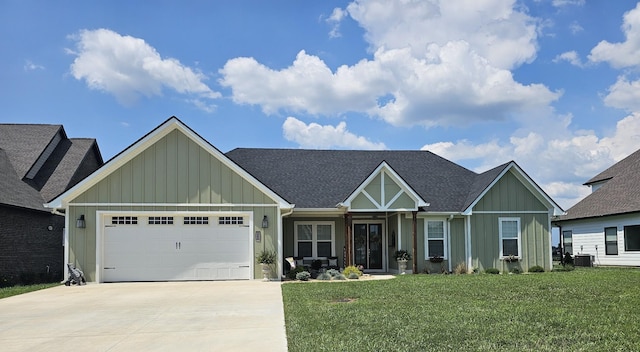 246 Lookout Dr, Winchester, TN 37398 - view of front facade featuring board and batten siding, an attached garage, driveway, a front yard, and roof with shingles