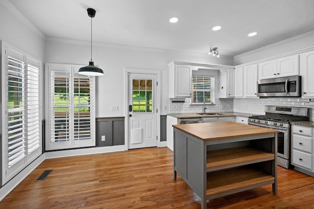 1204 Corlew Dr, Burns, TN 37029 - kitchen featuring stainless steel appliances, butcher block countertops, ornamental molding, white cabinets, and tasteful backsplash