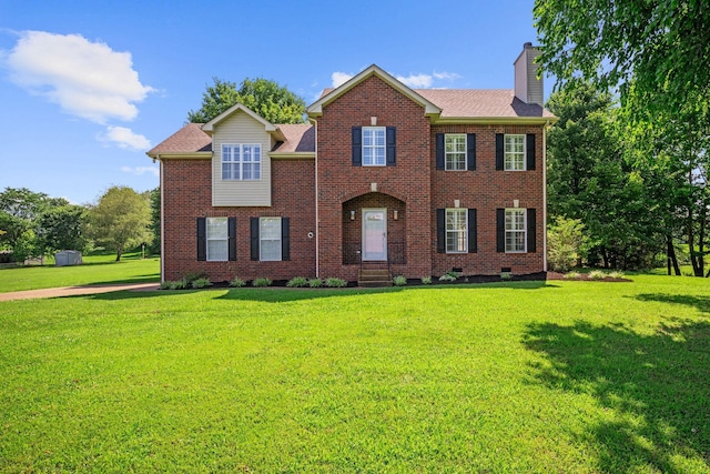 1204 Corlew Dr, Burns, TN 37029 - view of front of house featuring a chimney, a front lawn, brick siding, and crawl space