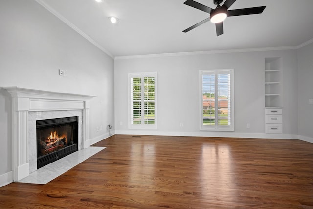 1204 Corlew Dr, Burns, TN 37029 - unfurnished living room featuring wood finished floors, built in shelves, ceiling fan, a high end fireplace, and ornamental molding