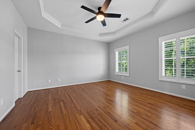 1204 Corlew Dr, Burns, TN 37029 - unfurnished room with a tray ceiling, ceiling fan, ornamental molding, and dark wood-style floors