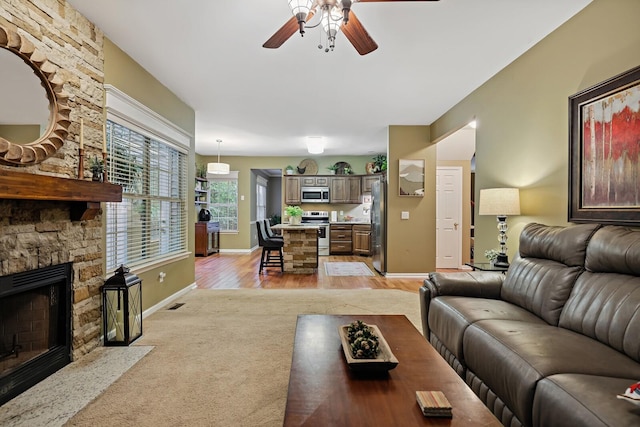 1511 Cardinal Ln, Mount Juliet, TN 37122 - living room with a ceiling fan, light carpet, a fireplace, and light wood-style floors
