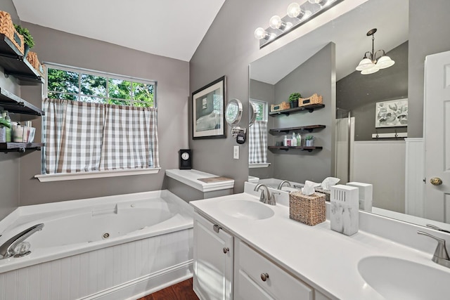 1511 Cardinal Ln, Mount Juliet, TN 37122 - bathroom featuring vaulted ceiling, a tub with jets, wood finished floors, and double vanity