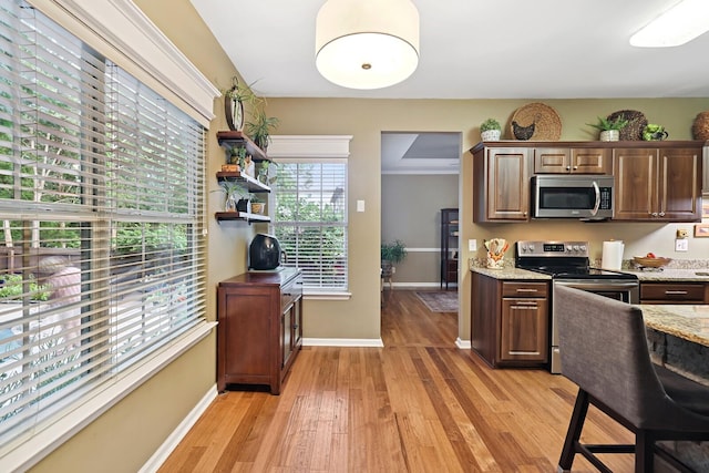 1511 Cardinal Ln, Mount Juliet, TN 37122 - kitchen featuring stainless steel appliances, light wood-style floors, light stone counters, and an office area