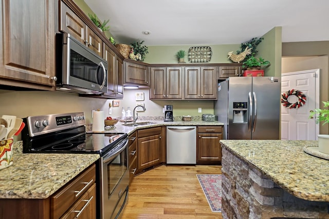 1511 Cardinal Ln, Mount Juliet, TN 37122 - kitchen featuring appliances with stainless steel finishes, light wood finished floors, and light stone countertops