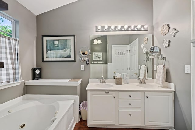 1511 Cardinal Ln, Mount Juliet, TN 37122 - full bath with double vanity, a tub with jets, vaulted ceiling, and wood finished floors